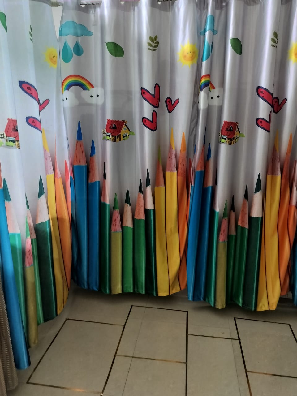 Curtains with pencil and rainbow graphics inside the learning room